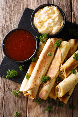 Homemade spicy chicken with chicken and two sauces close-up. Vertical top view