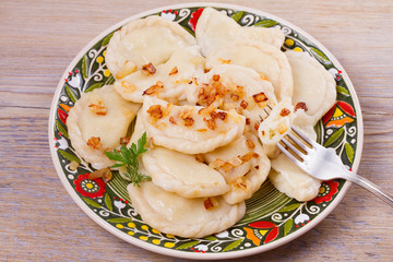 Dumplings, filled with potato and served with salty caramelized onion. Varenyky, vareniki, pierogi, pyrohy - popular dish in East Europe, horizontal