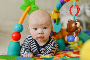 baby on the toy rug