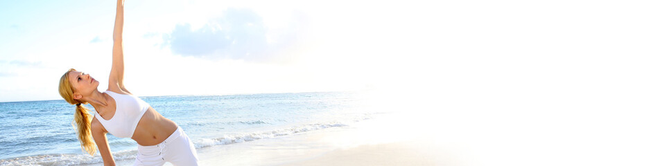 Fototapeta premium Beautiful woman doing yoga exercises by the beach - banner template web