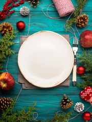 Christmas dark green background with empty dish and cutlery. Festive holiday dinner concept - 179660278
