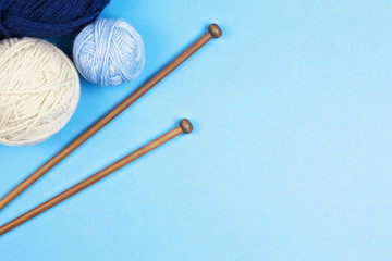 Knitting background. Knitting needles and balls of colorful yarn on white background