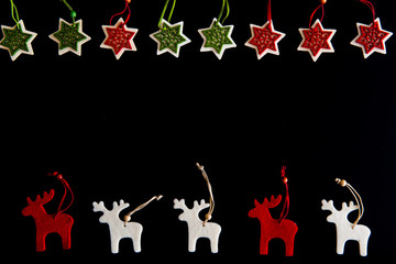 Fototapeta premium Felt rein deers and snowflakes isolated on black