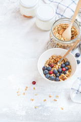 Baked oats granola with nuts and honey, milk and homemade yogurt.