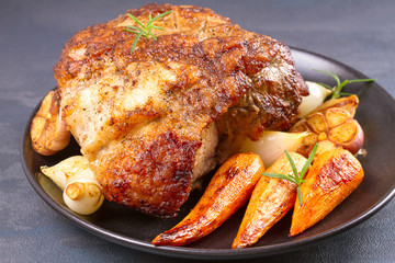 Roasted ham with vegetables on grey rustic background, horizontal