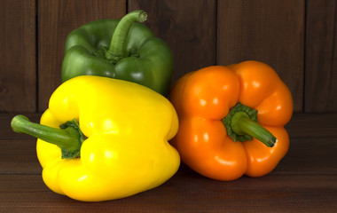 Juicy beautiful Bulgarian pepper on a wooden background