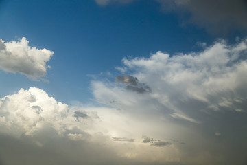 Naklejka na ściany i meble rain clouds on a blue sky as a background