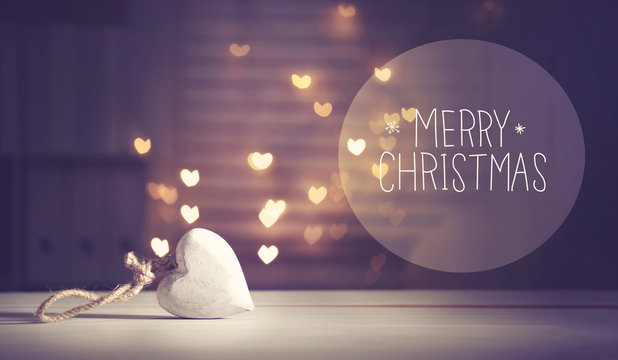 Merry Christmas message with a white heart with heart shaped lights
