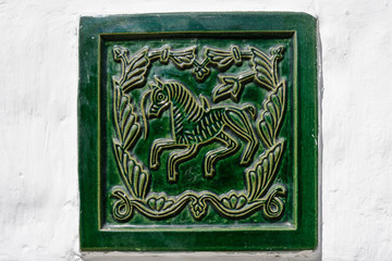 Green tile on white wall
