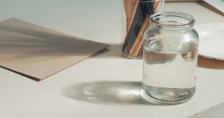 closeup of art tools in studio Paints, brushes, canvas, pencil