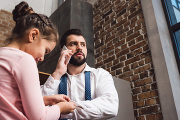 daughter fixing cufflinks for father