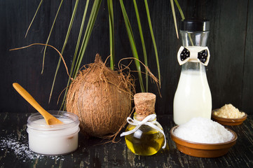 Various coconut products on black background