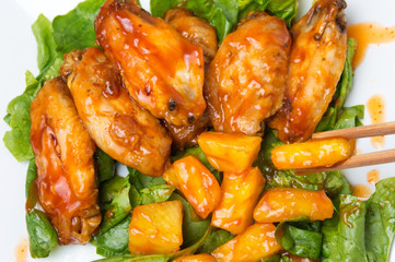 Pineapple chicken wings with barbecue and chili sauce