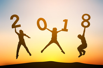 Silhouette people jumping with 2018 word at sky sunset, concept Happy New year