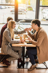Girlfriend giving piece of croissant to boyfriend