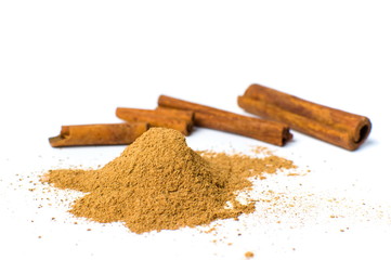 Cinnamon powder and sticks isolated