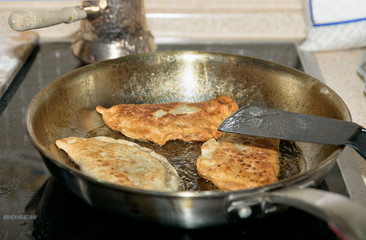 Chebureki are fried in pan. National dish of the Crimean Tatars and traditional for the Caucasian and Turkic peoples