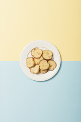 garlic cookies with dish on the color(blue, yellow) paper background.
