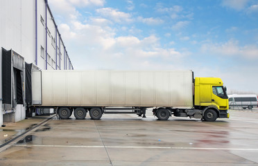 Fototapeta na wymiar Cargo truck at warehouse building