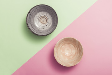 two asian bowl on the color(green, pink) paper background.