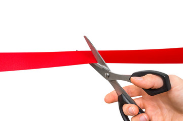 Hand with scissors cutting red ribbon - opening ceremony