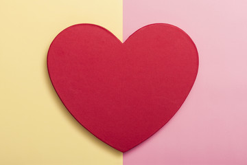 red heart gift box on the color paper background.