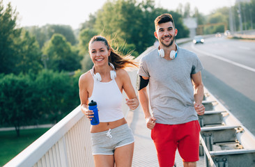 Attractive man and beautiful woman jogging together