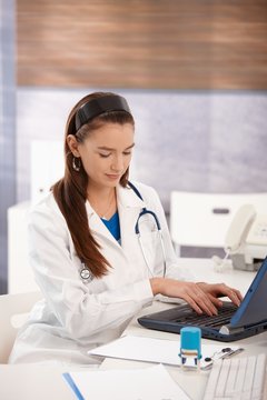 Portrait of young female doctor at doctors office