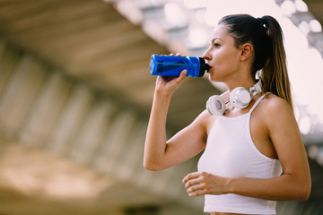 Portrait of woman taking break from jogging