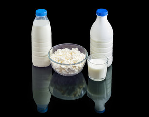 Milk and dairy products on a dark reflective surface