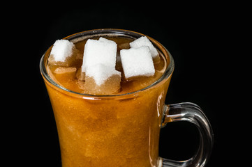 Many sugar cubes inside a cup of coffee