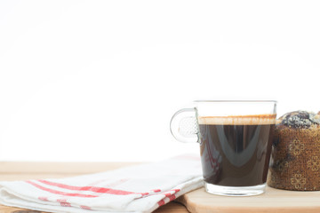 Cup of espresso on wooden table.