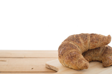 Croissant bread on wooden table.