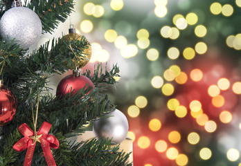 Christmas tree on abstract light golden bokeh background.