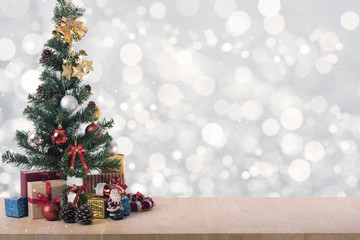 Fototapeta na wymiar Christmas tree on light silver bokeh background.