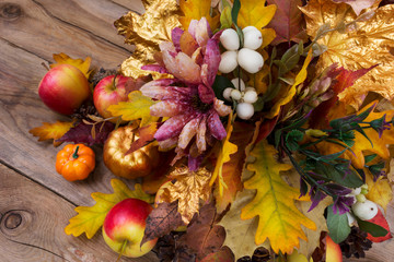Thanksgiving decoration with silk flowers, snowberry and fall leaves