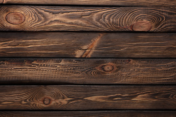 Texture of boards of dark old brown wood