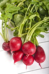 freshly harvested radish on a white wooden table