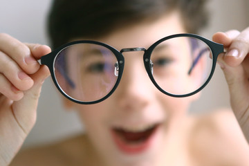 teenager kid boy in myopia correction glasses close up portrait 