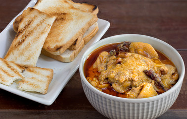 Massaman curry chicken in the bowl eat with Grilled bread in white dish