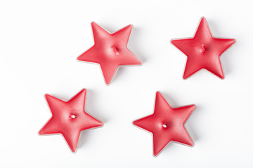 Candle in red star form, isolated on white