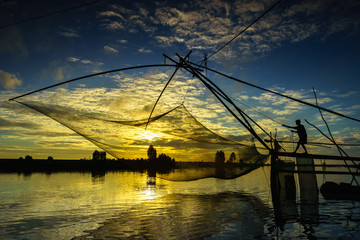 Sunrise scene in Tha La cultivation field with fishing net in Chau Doc, An Giang province, South Vietnam