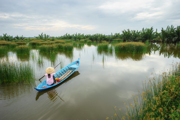 Landscape with rowing boat on rush field in Ca Mau province, Mekong delta, South Vietnam