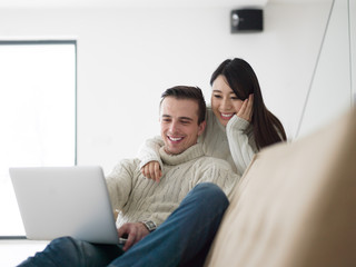 multiethnic couple using laptop computers