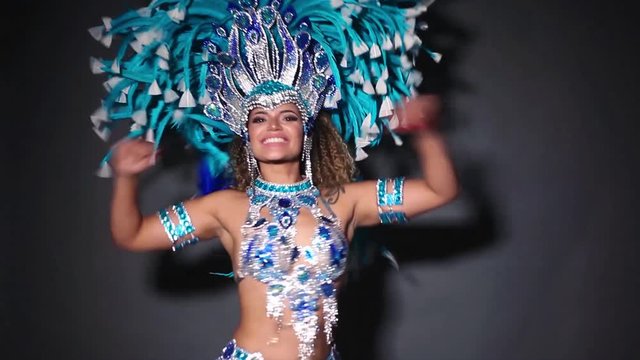 Beautiful and happy woman dancing samba while wearing traditional costume