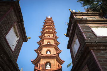 Fototapeta na wymiar Old tower at Tran Quoc the oldest temple in Hanoi, Vietnam
