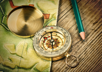 old map and compass on a wooden table