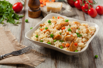 Delicious risotto with chicken and green peas. © gkrphoto