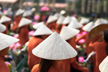 Vietnamese girls wear traditional long dress Ao Dai cycling on Hanoi street