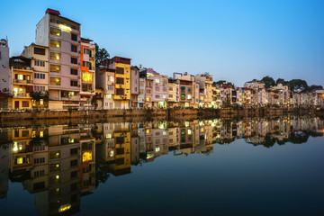 Fototapeta premium Resident houses and reflection on Tinh Bien lake in Hanoi, Vietnam
